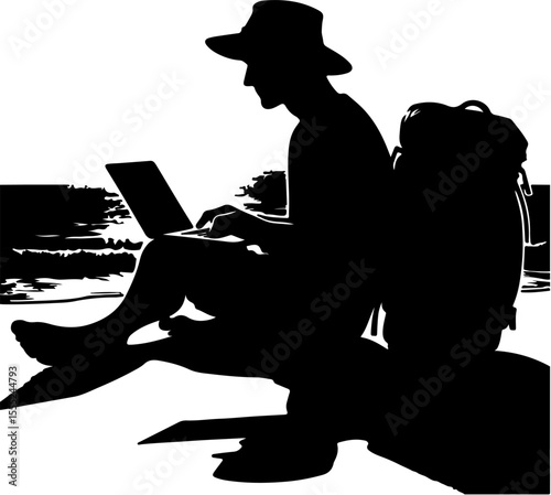 silhouette of a man using a laptop