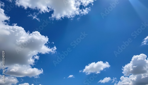beautiful blue sky with fluffy white clouds as a background, subject on the left, ample copy space on the right, optimized for photo use.
