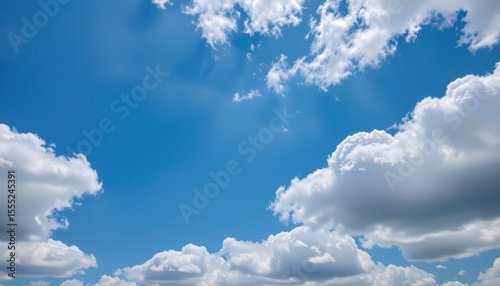 photo of a blue sky background with white clouds and a clear subject positioned to the left with plenty of copy space to the right for added text or branding.