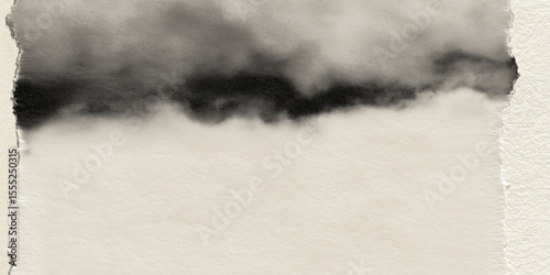 Abstract black watercolor painting on torn beige paper creating negative space