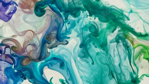 Vivid Close-Up of Swirling Blue and Green Ink in Water