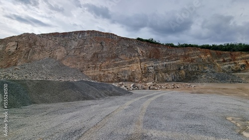 Gravel Quarry with Steep Rock Wall and Cloudy Sky