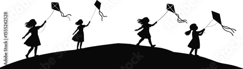 Little girls enjoy flying kites silhouette on a hill, experiencing the joy of childhood and outdoor activity