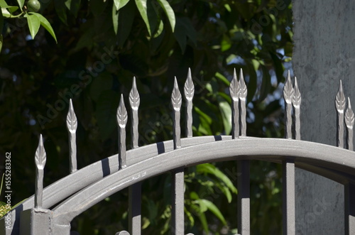 Arrows on top of metal fence