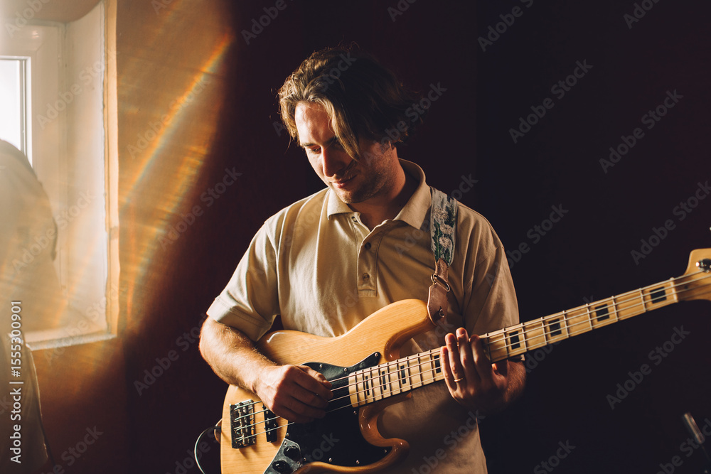 Obraz premium Musician playing bass guitar in recording studio