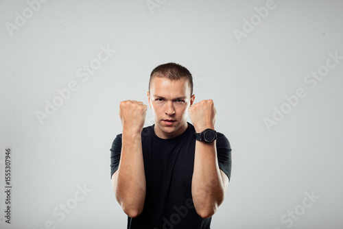 Tableau sur toile Confident Man Showing Fist Gesture on Gray Background