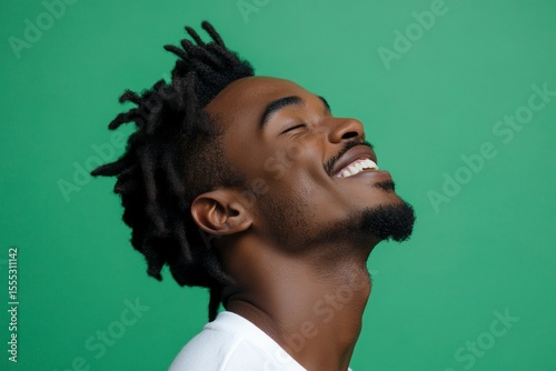 Green solid background. A trendy and radiant male showcasing style. Concept drawing of style for aging men. Trendy men's short dreads haircut - midlife white man with black hair.