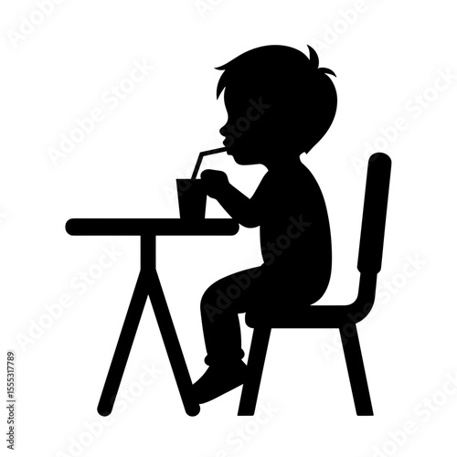 Silhouette of child drinking juice while sitting at table in cafe  