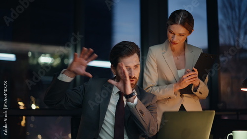 Smiling teammates video calling laptop evening workplace. Businessman explaining