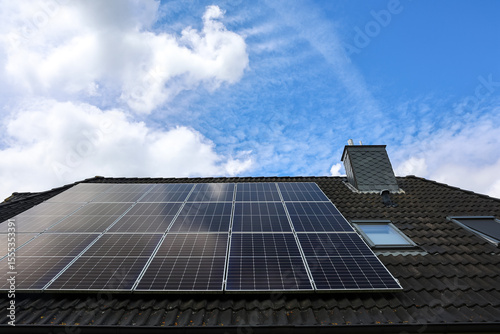 Photovoltaic panels providing clean energy on a rooftop under a cloudy sky