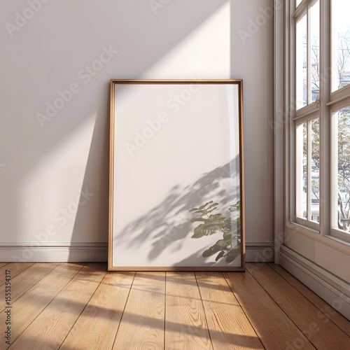 Blank framed artwork leaning against a wall in a sunlit room, suitable for home decor, interior design, and product display mockups.