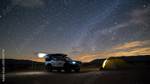 Camp setup with tent and vehicle under starry night sky, low horizon
