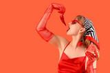 Young woman with fresh watermelon and chili pepper on red background