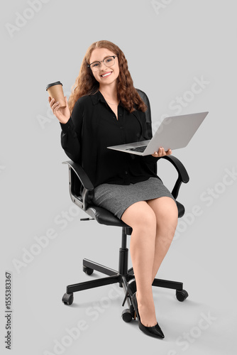 Young businesswoman with la...