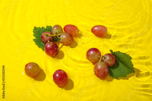 Tasty ripe grapes with leav...