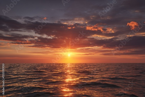 Dramatic Sunset over Ocean with Golden Reflections and Textured Clouds, Peaceful Seascape
