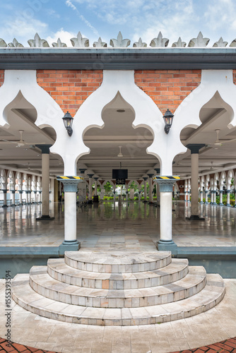 The grandeur of Sultan Abdul Samad Jamek Mosque in Kuala Lumpur, Malaysia during a tranquil day. The intricate architecture draws attention, highlighting its cultural significance and beauty