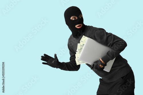 Male thief with laptop and ...