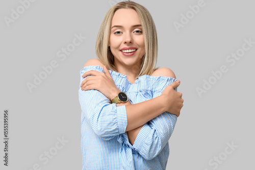 Young woman embracing herse...