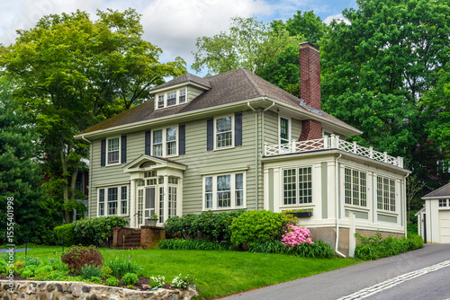 Photos Stylish two-story house with sunroom and manicured front yard garden in Newton,