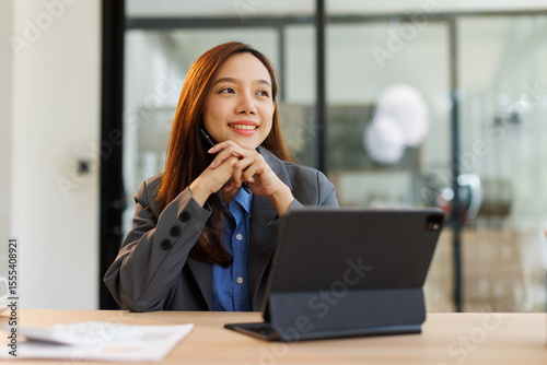 Asian female professional executives experts discussing financial accounting papers working workplace office.
