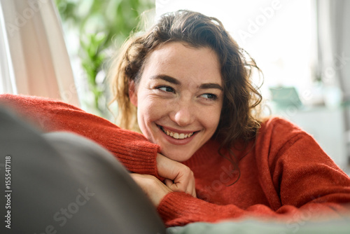 Fotografia Happy relaxed calm beautiful lady enjoying comfort thinking or good on soft sofa looking away