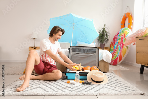 Male tourist packing headph...