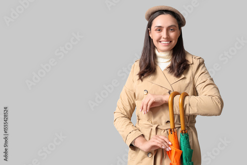 Happy young woman with umbr...