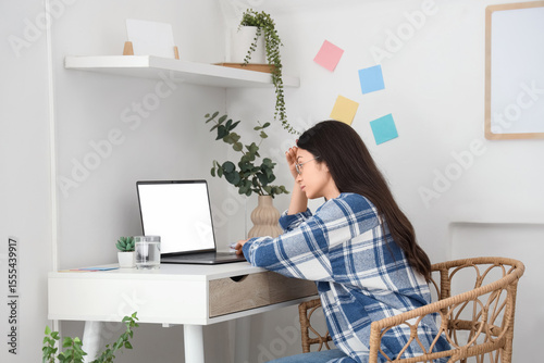 Tired young woman working w...