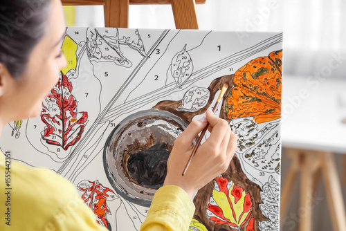 Woman painting by numbers o...