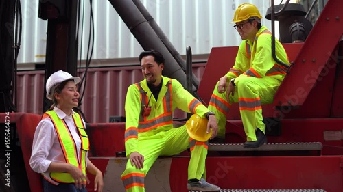 group of Diversity Engineers japan Foremen and asian Supervisors woman take a break resting on forklift talking together in Shipping Cargo Container Terminal Depot teamwork
