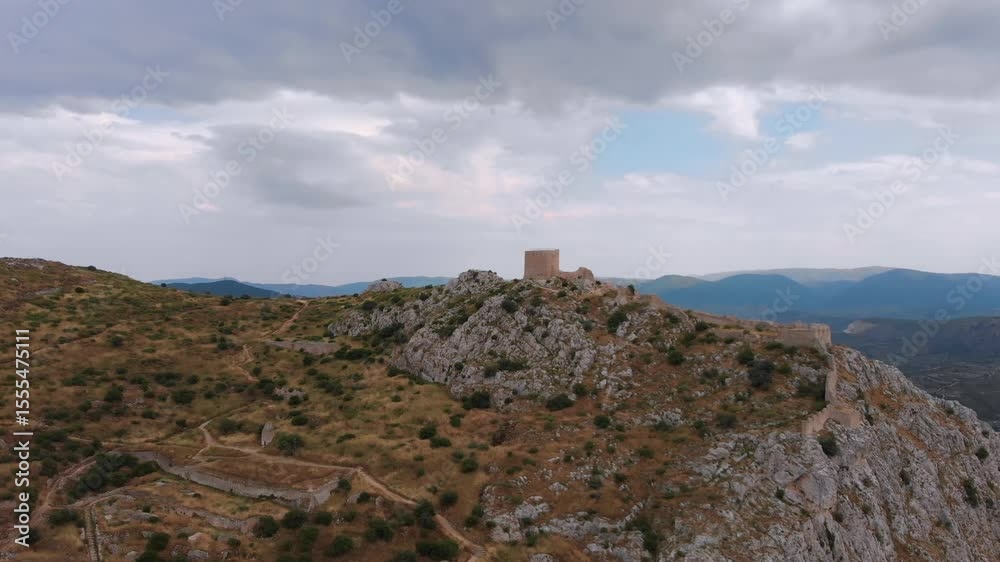 aerial drone panoramic view of the historic medieval castle of Acrocorinth, an ancient citadel perched atop a monolithic rock overlooking the ancient city of Corinth and the surrounding landscape in P aerial drone panoramic view of the historic medieval castle of Acrocorinth, an ancient citadel perched atop a monolithic rock overlooking the ancient city of Corinth and the surrounding landscape in P