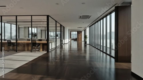 Modern office hallway with glass partitions and natural light