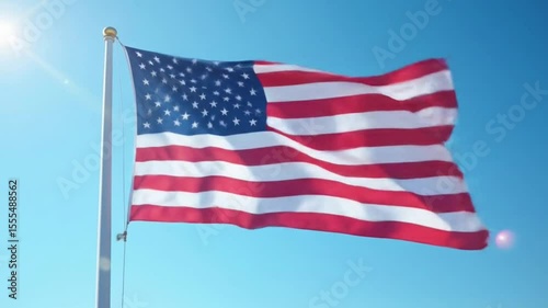 Flag Waving in the Breeze Against a Clear Blue Sky