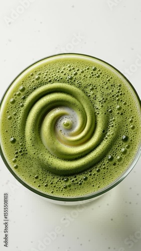 Frothy Matcha Latte Swirling with Creamy Milk Spiral