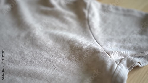 Close-up of an off-white fabric, showing texture and shadows