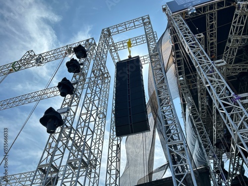Installation of professional sound speakers, line array and stage equipment for a concert.