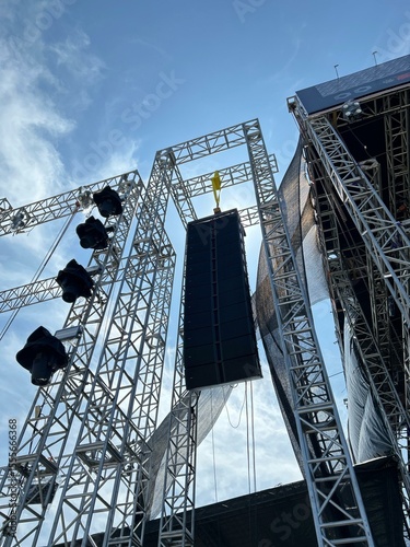 Installation of professional sound speakers, line array and stage equipment for a concert.