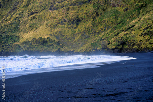Scene of black sand beach with heavy sea wave in strom environment of iceland.