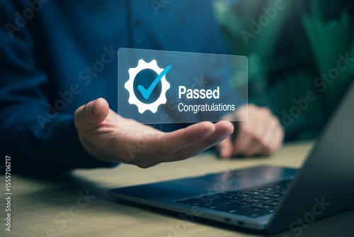 Hand holding transparent digital certificate displaying passed with congratulations for success