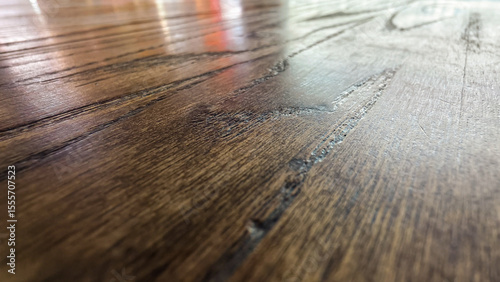 Detailed close-up captures the organic texture of richly toned hardwood grain surface