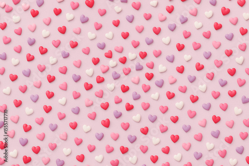 Colorful candy hearts arranged in a playful Valentine pattern.