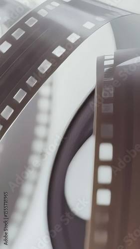 Vintage film reel spinning, exposing intricate mechanical details and nostalgic texture of analog cinema through mesmerizing circular motion