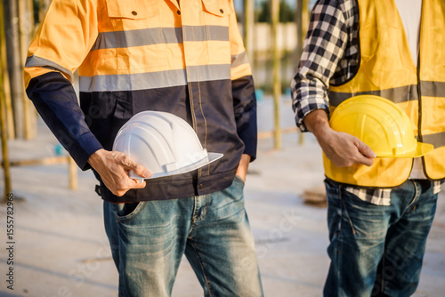 Photography An elderly engineer and a middle-aged man at a construction site engage in a ser