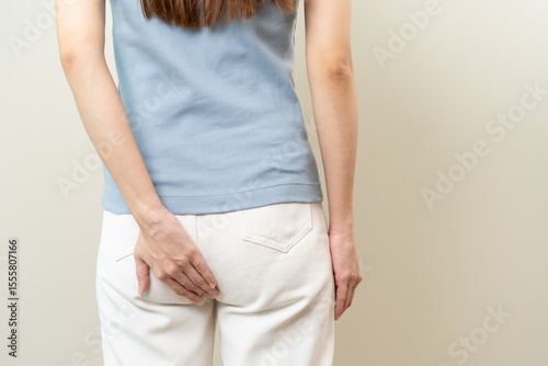 Health care, pain asian young woman suffering from hemorrhoid, anus, diarrhea and constipation, girl hand touching, holds butt, anal have abdominal, intestine problem, abscess disease and smell fart.