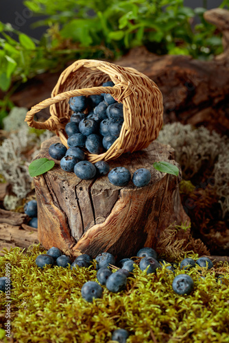 Small wicker basket filled with ripe blueberries.