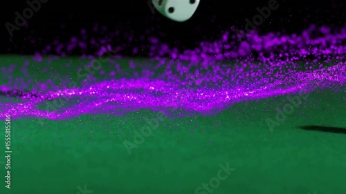 Descending white dice bouncing across green-felt while scattering purple particles to show motion