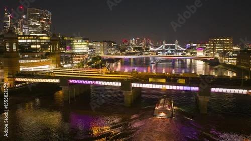 Traffic on water and on bridges over Thames river in city centre. Night hyperlapse shot