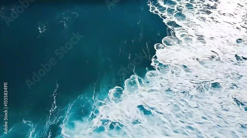 Aerial Ocean Wave Crashing: Turquoise Water, White Foam, Dynamic Movement.
