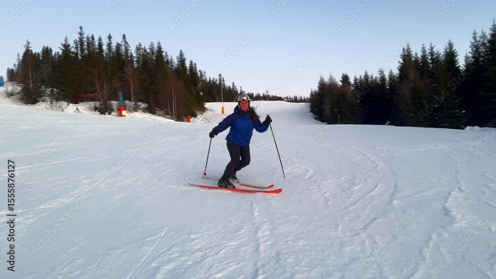 Telemark downhill skier skiing Hafjell Alpine ski resort Øyer mountain Norway Norge arctic sunset golden hour last run Olympic torch man Lillehammer clear skies groomed trail runs icy packed follow